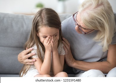 Loving Understanding Old Grandma Embracing Little Crying Girl Comforting Upset Granddaughter, Senior Caring Grandmother Hugging Child Consoling Kid In Tears, Grannys Empathy Support For Grandchild