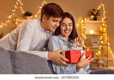 Loving young beautiful people gift giving, couple in love, boy and girl happy romantic emotion in Valentine day. Male, female close pair with present box, celebrating Saint Valentine's Day together  - Powered by Shutterstock