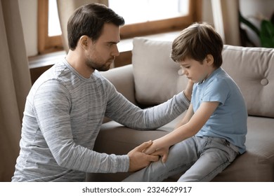 Loving young Caucasian father hug and cuddle unhappy small son, make peace reconcile after family fight. Caring dad comfort support upset sad little boy child feeling bad. Loner, depression concept. - Powered by Shutterstock