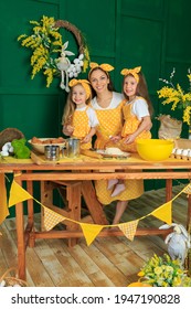 Loving Young Caucasian Mother Cooking Baking Together With Preschooler Daughters In Rustic Kitchen. Caring Millennial Mom, Little Girls Children Roll Dough Do Bakery Pastries Cookies At Home. Easter