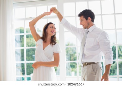 Loving Young Couple Dancing At Home