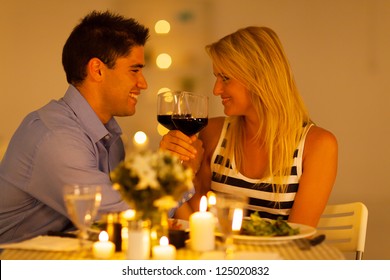 loving young couple enjoying a glass of wine in restaurant