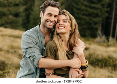 Loving young couple hugging and smiling together on nature background. High quality photo - Shutterstock ID 1928497952