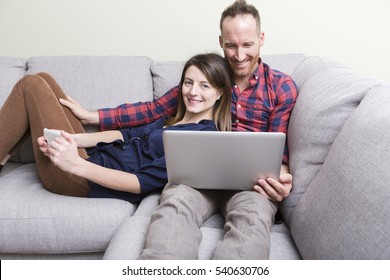 A Loving young couple sitting on the couch at home