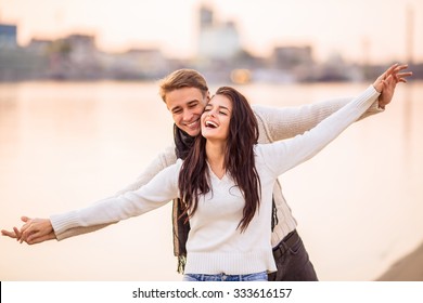 Loving young couple walk on the beach in autumn - Powered by Shutterstock