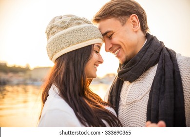 Loving Young Couple Walk On The Beach In Autumn