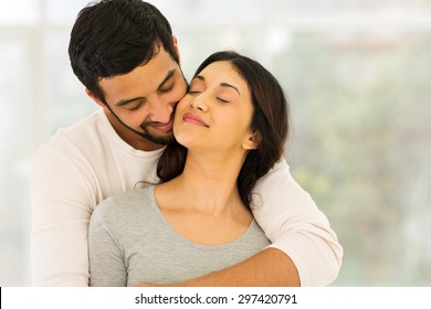 loving young indian couple embracing at home  - Powered by Shutterstock