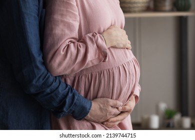 Loving young man and pregnant woman holding hands on belly, feeling inspired waiting for first baby, showing unconditional love, prenatal care, third trimester, IVF advertisement, childbirth concept.