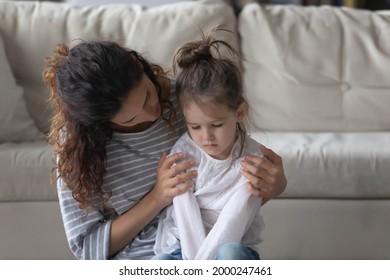 Loving Young Mom Hug Cuddle Small Preschooler Daughter, Make Peace Or Reconcile After Family Fight. Caring Mother Embrace Comfort Little Girl Child Or Kid Feeling Sad Upset. Generation Gap Concept.