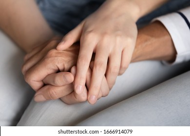 Loving Young Woman Hold Senior Mother Hands Show Support And Care, Close Up Of Supportive Adult Grownup Daughter Help Comfort Mature Mom, Share Close Tender Intimate Family Moment Together