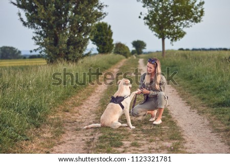 Image, Stock Photo Loving young woman offered a paw by her dog