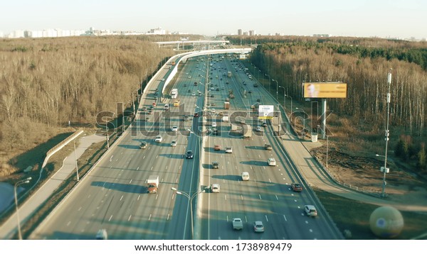 Low altitude aerial view of a wide highway in\
spring. Moscow, Russia