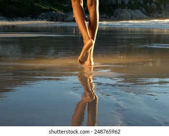 Low angle african american woman walking alone on the beach