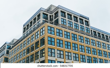 Low Angle Architectural Exterior View Of Modern Low Rise Mixed Use Residential And Commercial Urban Building On Overcast Day