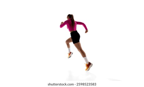 Low angle back view image of young sportive woman, running athlete in motion, training isolated on white studio background. Concept of athletics, sport, endurance, fitness, healthy lifestyle. Ad