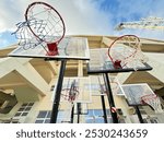 Low angle of basketball hoops in front of the Pankritio Stadium of Crete - Under the amazing blue sky - Ball games - Looking forward to new games