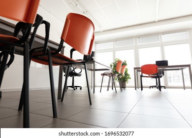A low angle of a bright office room with no people during the corona virus pandemic.