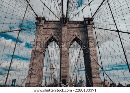 Low angle of brooklyn bridge on a cloudy day in New York City 