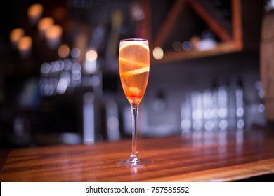 Low Angle Close Up On A Glass Of Sparkling Champagne In Traditional Crystal Flute Wine Glass With Carbonated Bubbles Fizzing Around A Lemon Peel Garnish