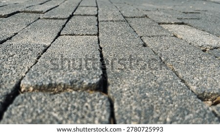 Low angle close up of paving block surface with shallow depth of field