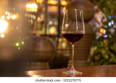 Low Angle Close Up Perspective Of Crystal Clear Wine Glass In Warm Light Background