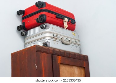 low angle close up of suitcase above wooden cup board