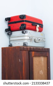 low angle close up of suitcase above wooden cup board