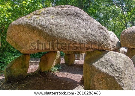 Low angle close up view of Dolmen (hunebed) D27 close to Borger in the Netherlands which is a megalithic tomb or burial mound with large stones dating back to Neolithic period, about 5.000 years ago
