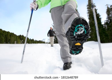 A Low Angle Closeup Of Women?s Shoe Bottom While Taking A Step In The Snow