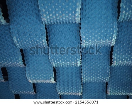 A low angle closeup shot of a ceiling covered in blue sound dampening fabric