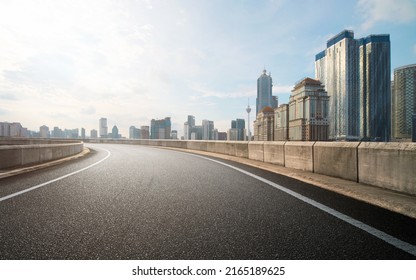 Low angle curvy flyover highway moving forward road with kuala lumpur cityscape evening scene view. - Shutterstock ID 2165189625
