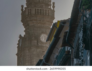 Low angle frontal medium shot of a the clerigos tower under a clear sky, historic center of porto city, portugal