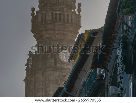 Low angle frontal medium shot of a the clerigos tower under a clear sky, historic center of porto city, portugal