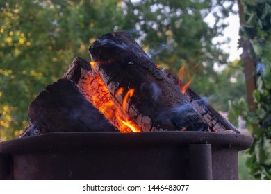 Low angle ground level view of a blazing camp fire with orange flames