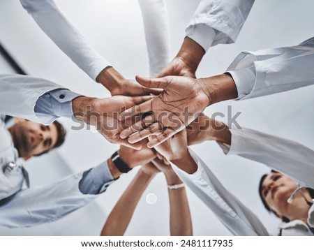 Low angle, hands stack and medical people in hospital for healthcare support, solidarity and teamwork of workforce. Staff, diversity and collaboration, trust and synergy together for partnership
