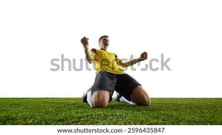Low angle image of young man, soccer player celebrating victory, dropping to knees, fists clenched, shouting with joy after scoring goal. Concept of success, excitement, achievement, sport.