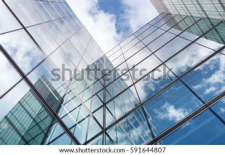 Low angle looking up at tall corporate glass buildings. 