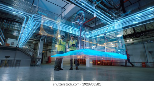 Low angle of male colleagues in vests and hardhats examining and discussing 3D plan of modern wind power station in workshop of factory - Shutterstock ID 1928703581