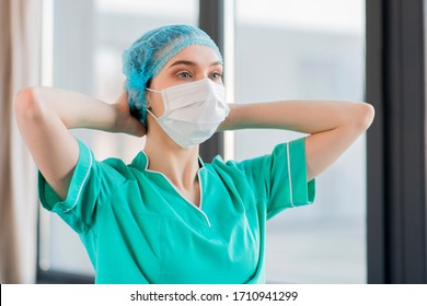 Low angle nurse tired with medical mask - Shutterstock ID 1710941299