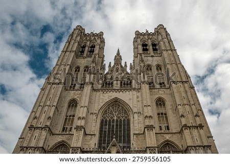 Low angle perspective view on Facade of the Cathedral of Brussels or Cathedral of St. Michael and St. Gudula in Brussels, Belgium under dramatic cloudy sky