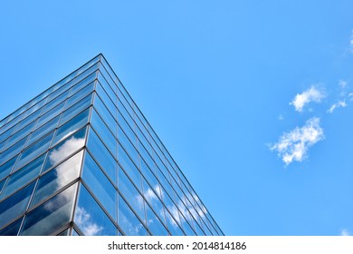 Low angle photography of glass curtain wall details of high-rise buildings.The window glass reflects the blue sky and white clouds