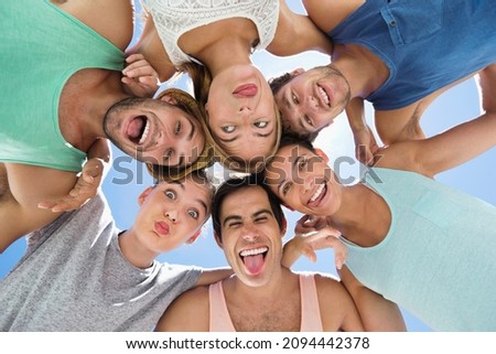 Similar – Young people with their heads together having fun