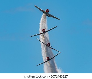 A low angle shot of airplane stunts on an airshow