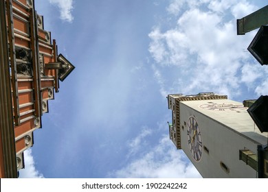 A low angle shot of the clock tower and building with a cloudy background