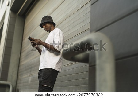 Similar – Attractive black man listening to music with earphones