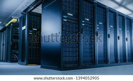 Low Angle Shot of Data Center With Multiple Rows of Fully Operational Server Racks. Modern Telecommunications, Cloud Computing, Artificial Intelligence, Database, Supercomputer Technology Concept.