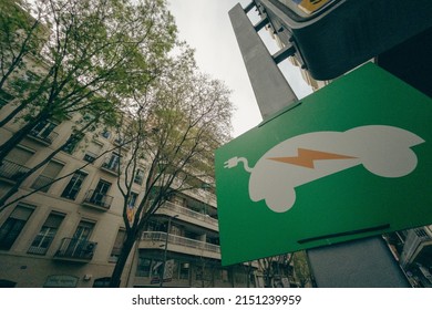 A Low Angle Shot Of An Electric Car Charging Sign In A City