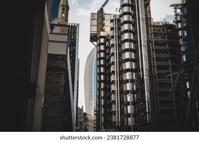 A low angle shot of the Fenchurch Building behind Lloyd's of London