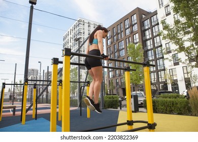 Low Angle Shot Of A Fitness Woman Doing Dips Exercise During Street Workout In The City