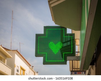 A low angle shot of a green sign of a pharmacy with a green hear - Shutterstock ID 1635169108
